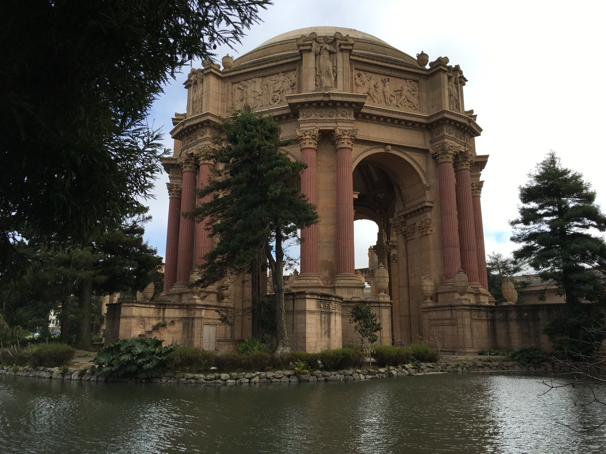 A preserved classical rotunda and colonnade beside a lagoon
