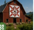 A red barn with a painted quilt block